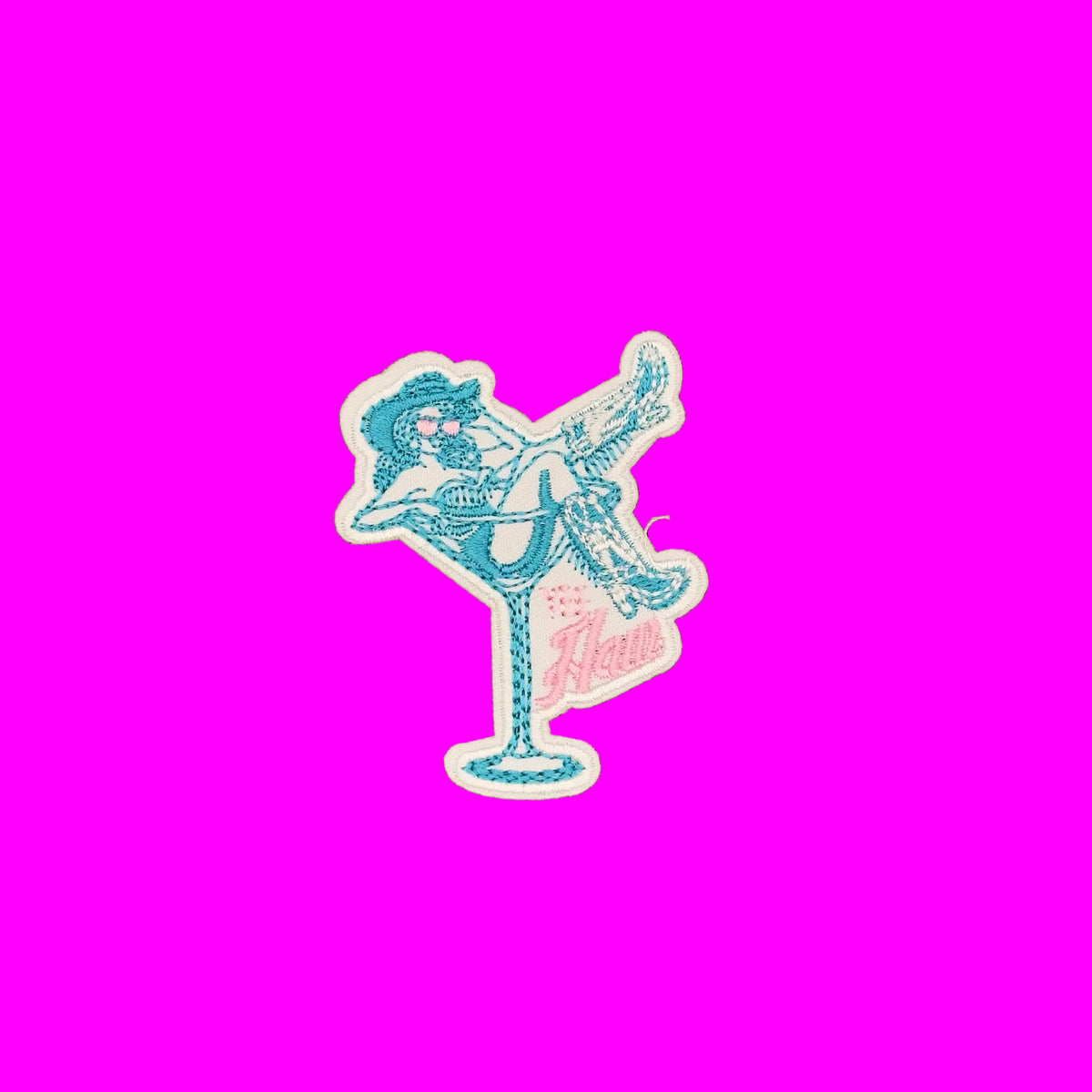 An embroidered iron-on patch featuring a blue stylized retro female figure posed in a tilted martini glass with pink script text reading 'Yeehaw'.