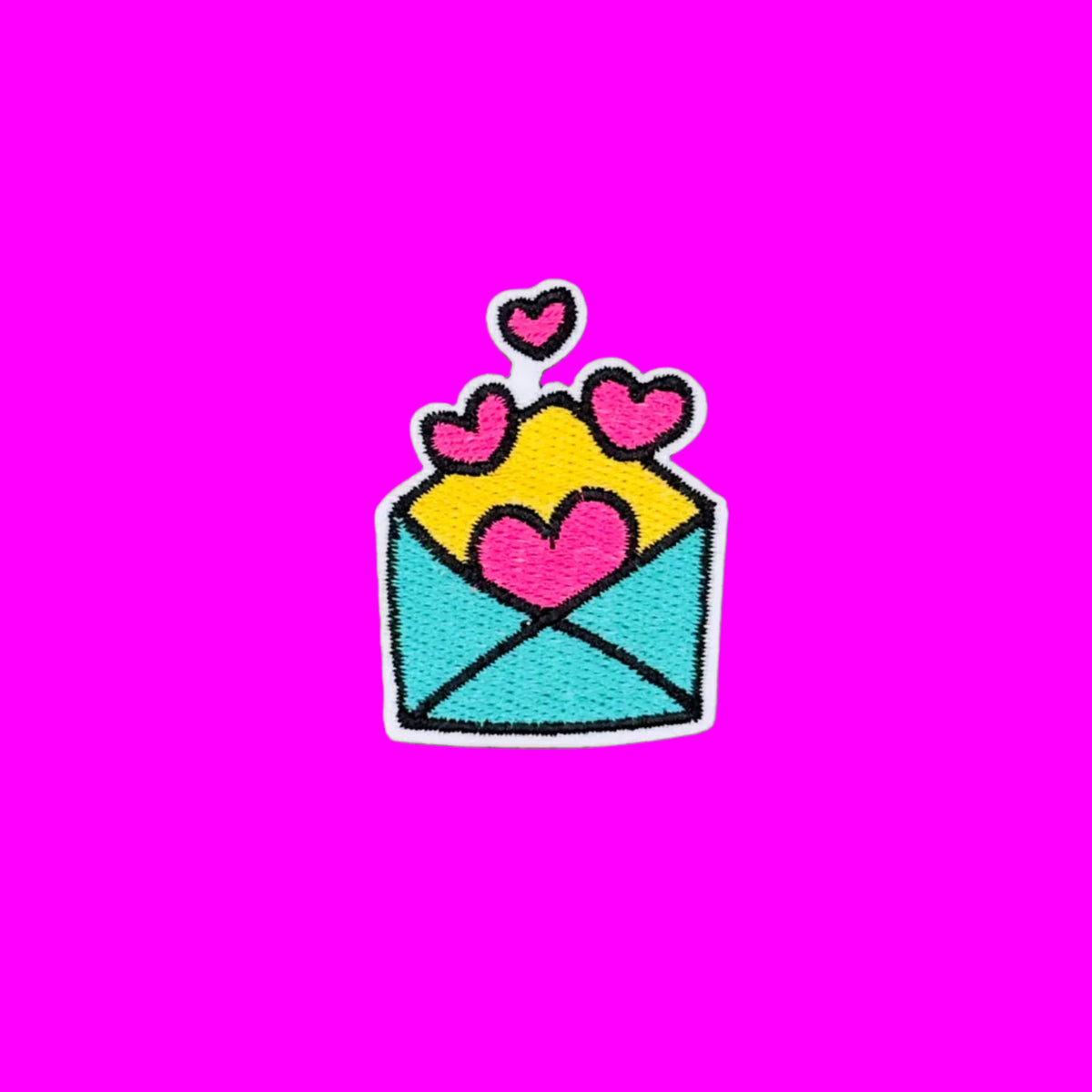 Teal envelope with pink hearts embroidered iron-on patch.