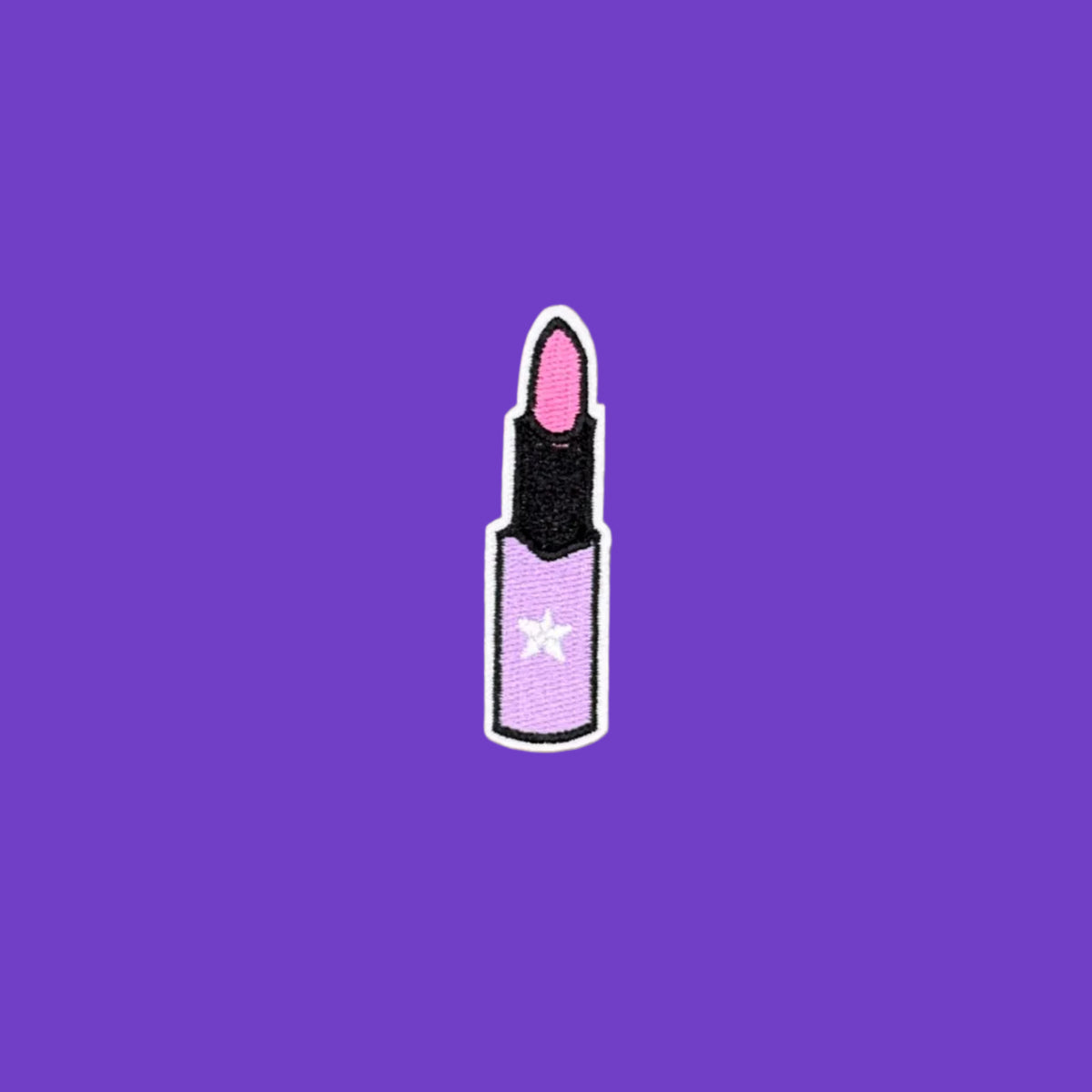 Pink lipstick in a black and purple tube embroidered iron on patch.