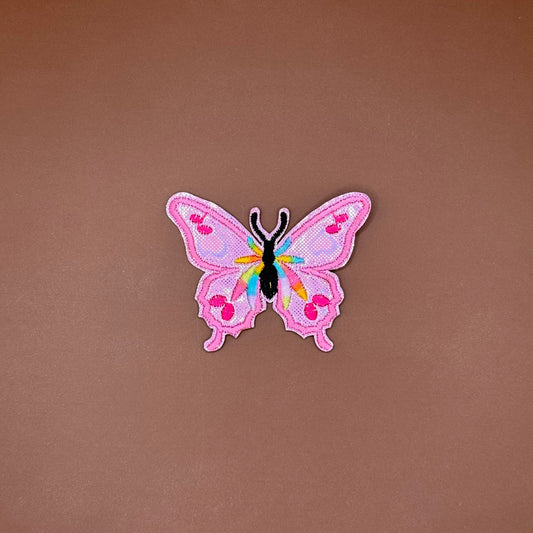 Iridescent pink butterfly iron-on patch with a rainbow body and hot pink spots