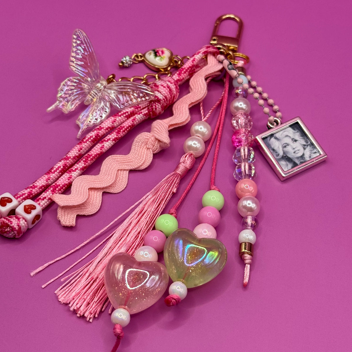 Close-up of the 1-of-1 Butterfly Ric-Rac Dolly bag charm by PrettyMUCH in soft romantic pinks.