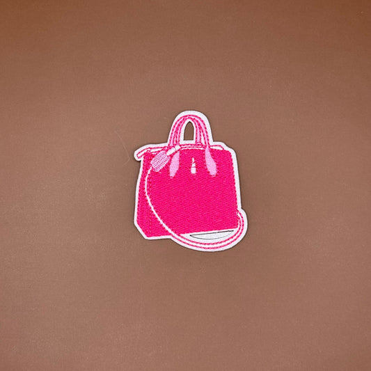 Hot pink top-handle handbag iron-on patch with a long crossbody strap