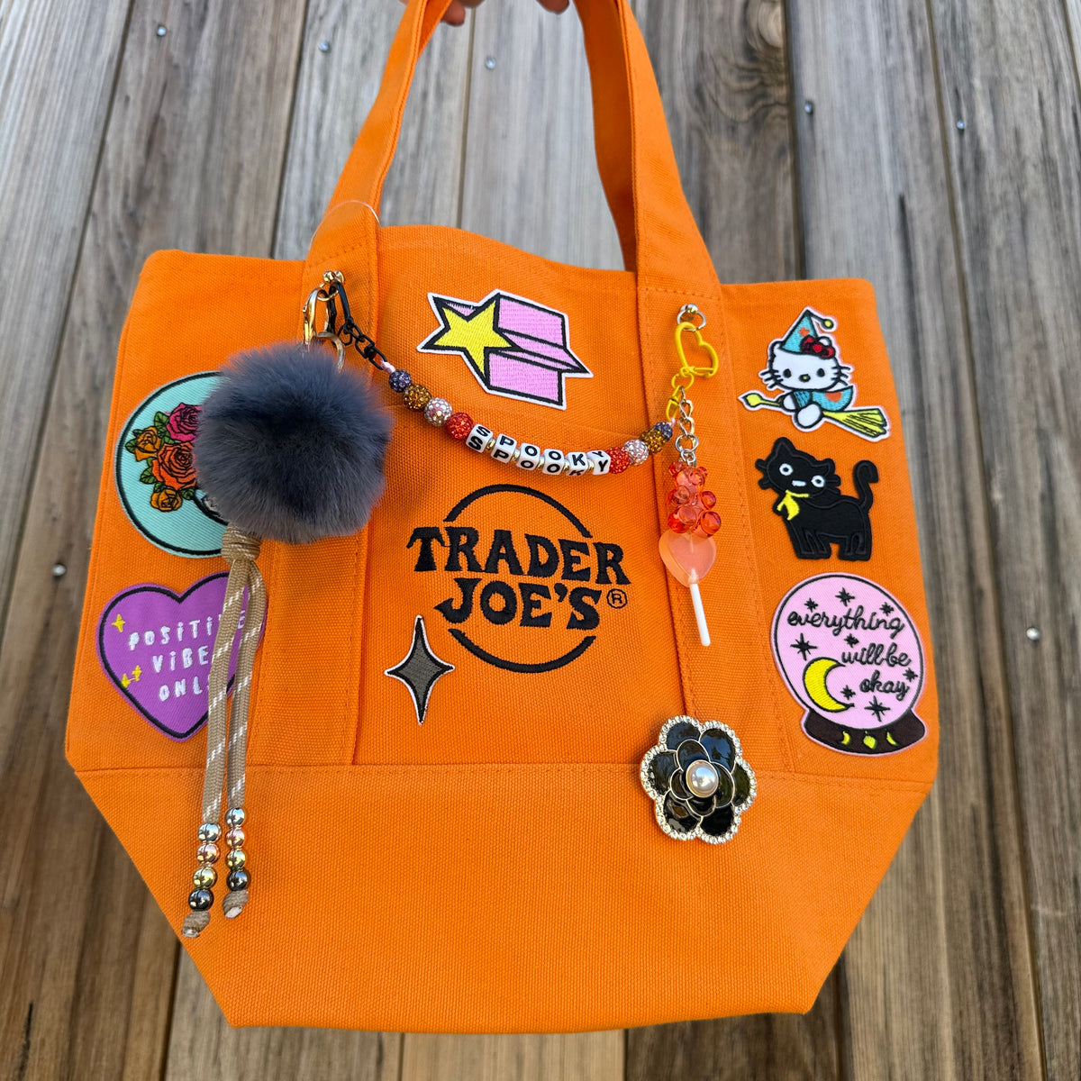 Detail of the custom Halloween Trader Joe's mini tote with spooky patches and charms
