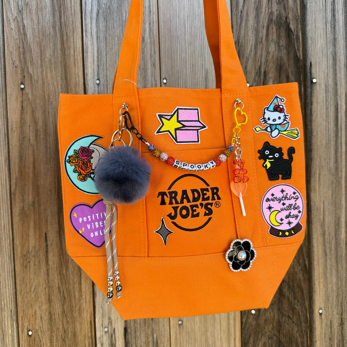 Detail of the custom Halloween Trader Joe's mini tote with spooky patches and charms