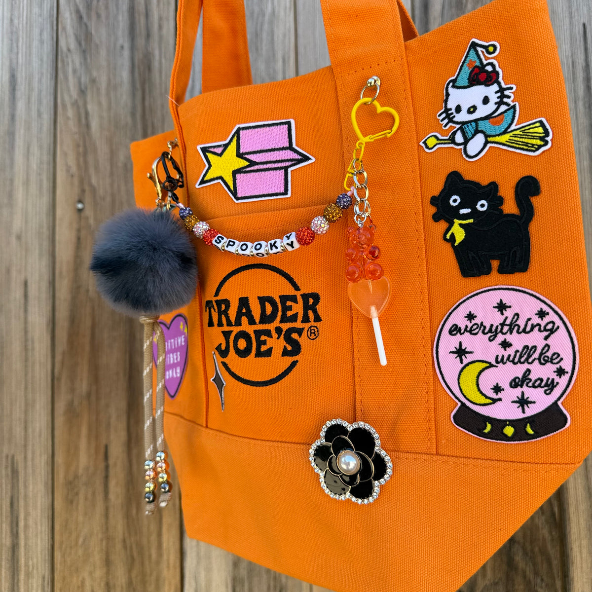 Detail of the custom Halloween Trader Joe's mini tote with spooky patches and charms