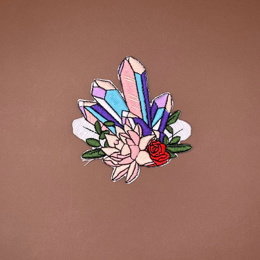 Embroidered iron-on patch of pink, lilac and blue quartz points set into blush flowers