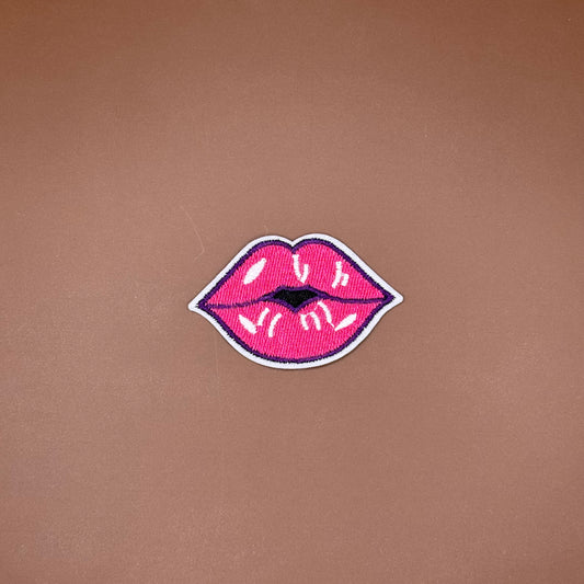 Hot pink lips iron-on patch outlined in deep plum with a glossy highlight