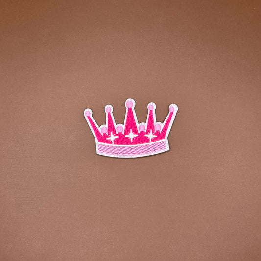 Five-point crown iron-on patch in two shades of pink with sparkle accents