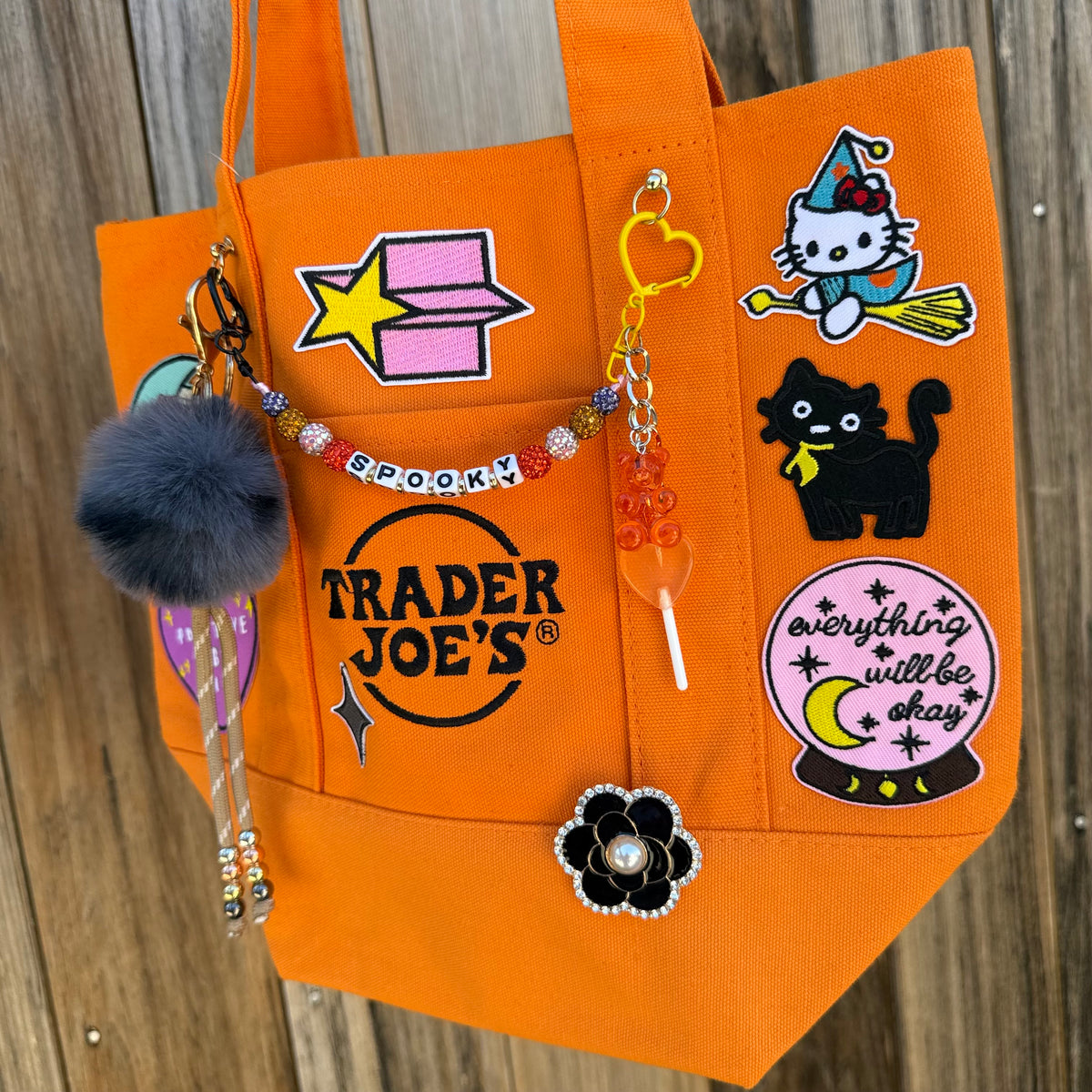 Detail of the custom Halloween Trader Joe's mini tote with spooky patches and charms