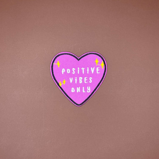 Purple heart iron-on patch with white Positive Vibes Only lettering and yellow sparkles