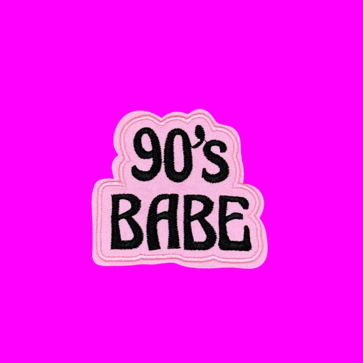 90s Babe written in black letters on a pink background iron-on embroidered patch.