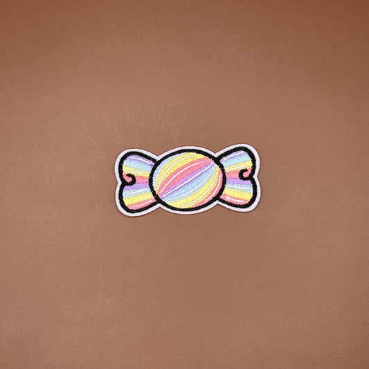 Pastel rainbow iron-on patch arcing over pink script lettering