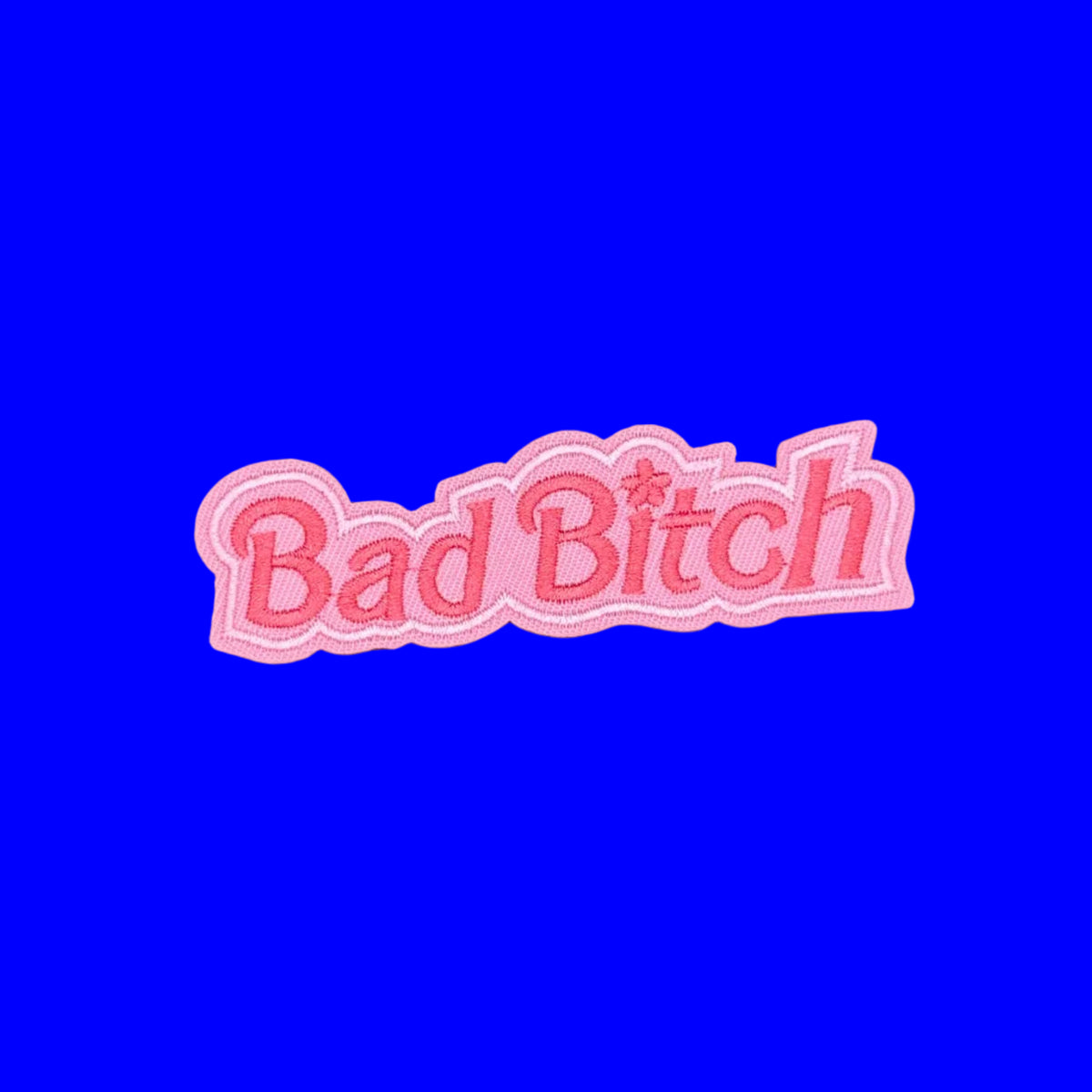 Bad Bitch written in pink letters on a pink background border embroidered iron on patch.