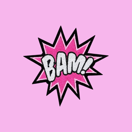 Pink comic starburst iron-on patch with BAM in bold white letters