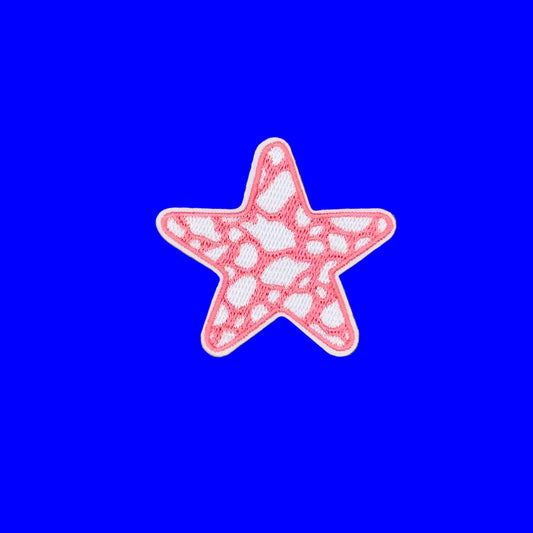 A pink and white embroidered starfish patch on a solid brown background.