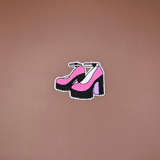 Iron-on patch of pink ankle-strap heels on chunky black platforms