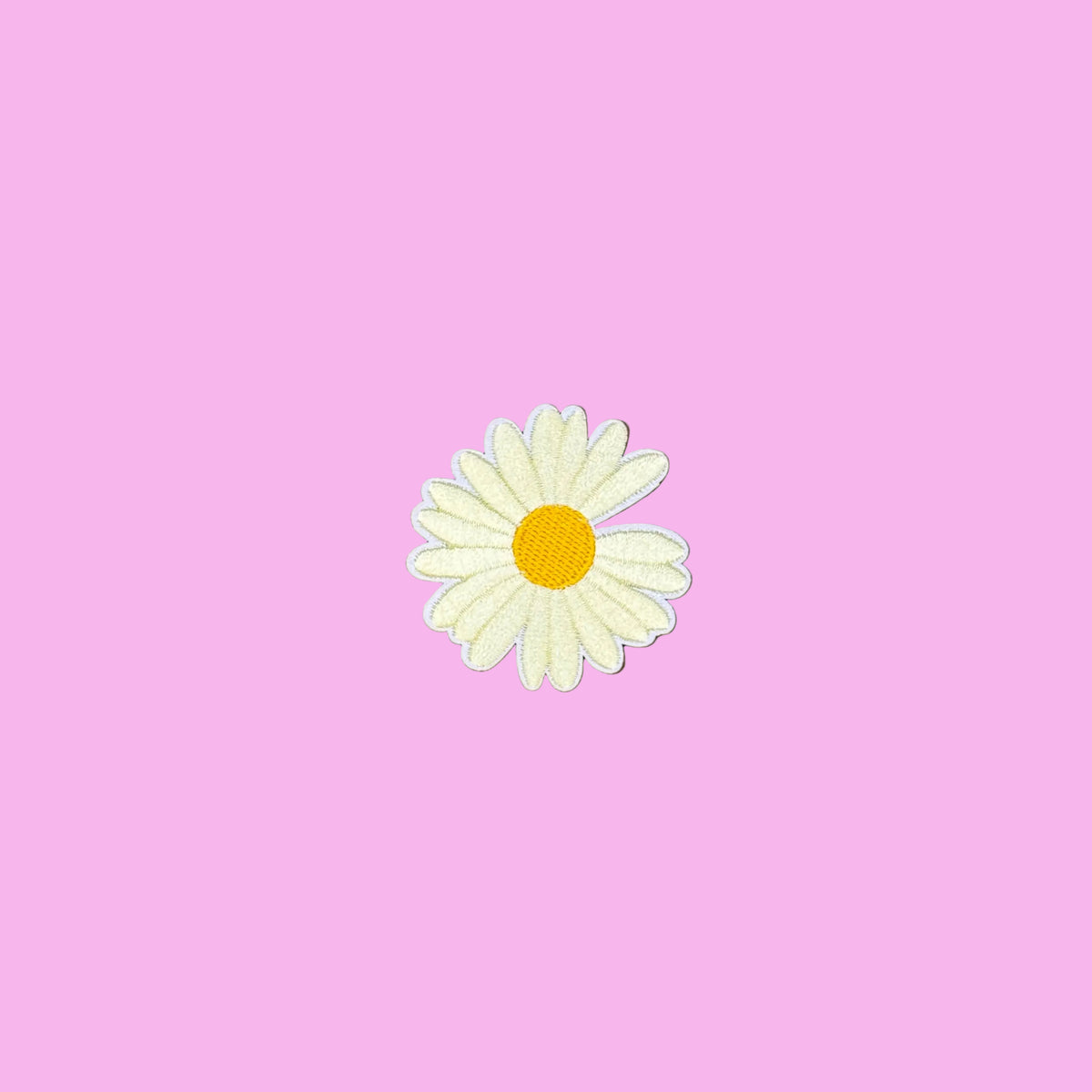 Ivory daisy embroidered iron-on patch with a yellow center