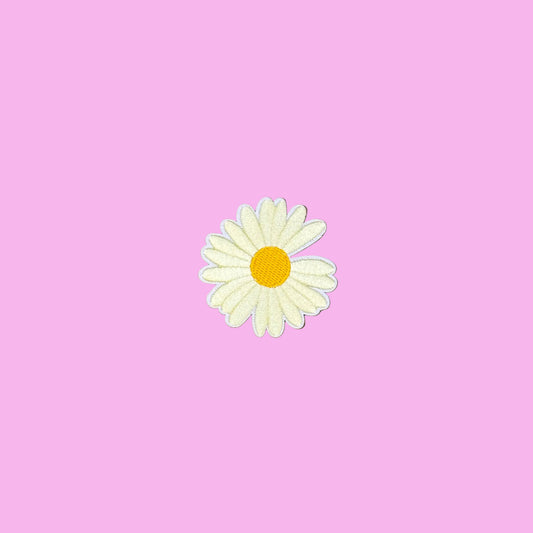 Ivory daisy embroidered iron-on patch with a yellow center