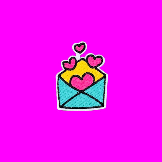 Teal envelope with pink hearts embroidered iron-on patch.