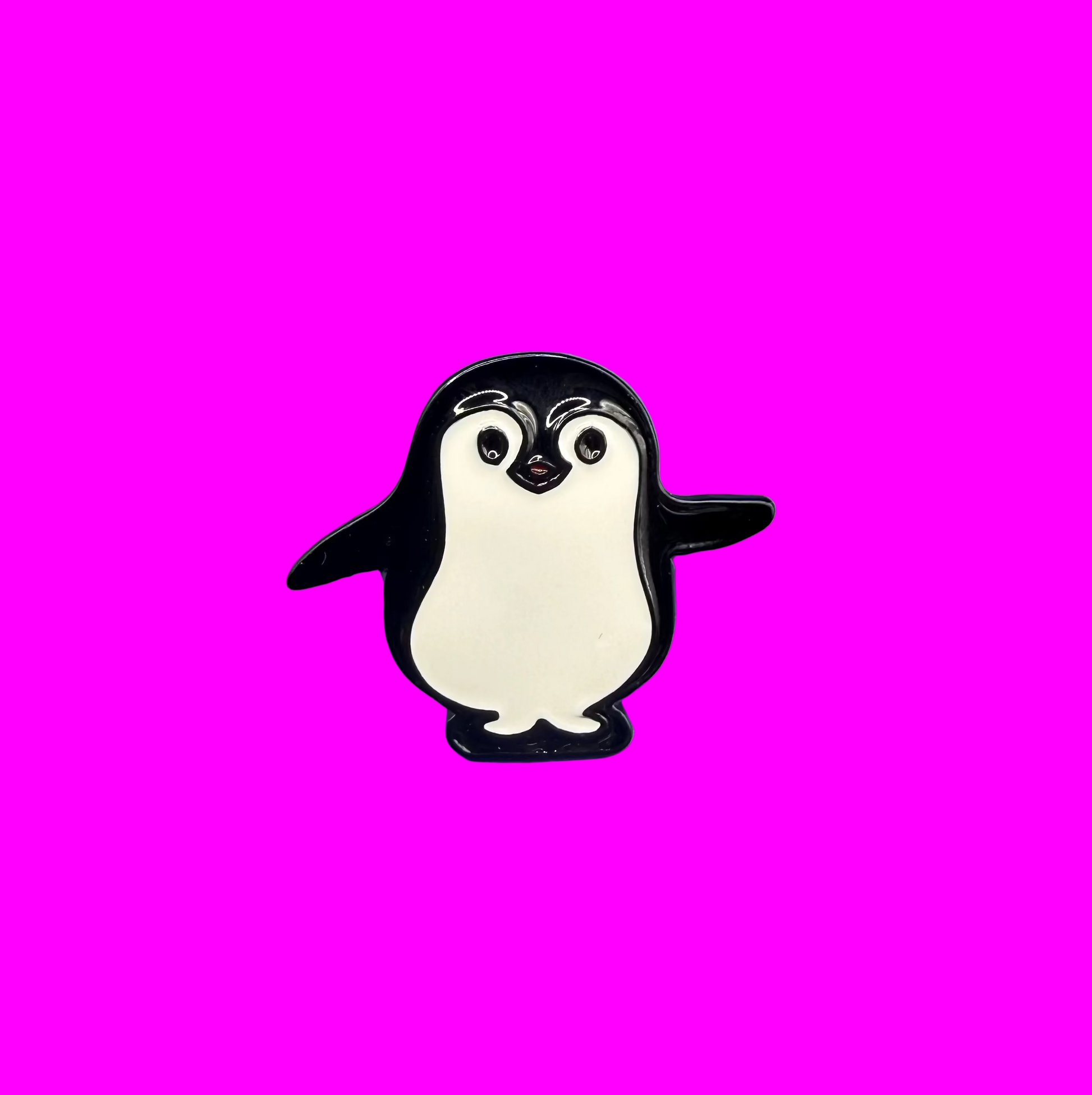 Black and white waddling penguin enamel pin