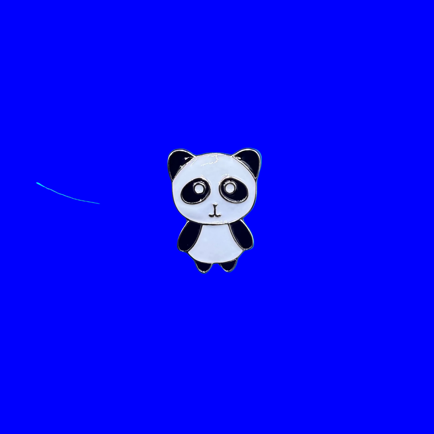 Wide-eyed black and white panda enamel pin