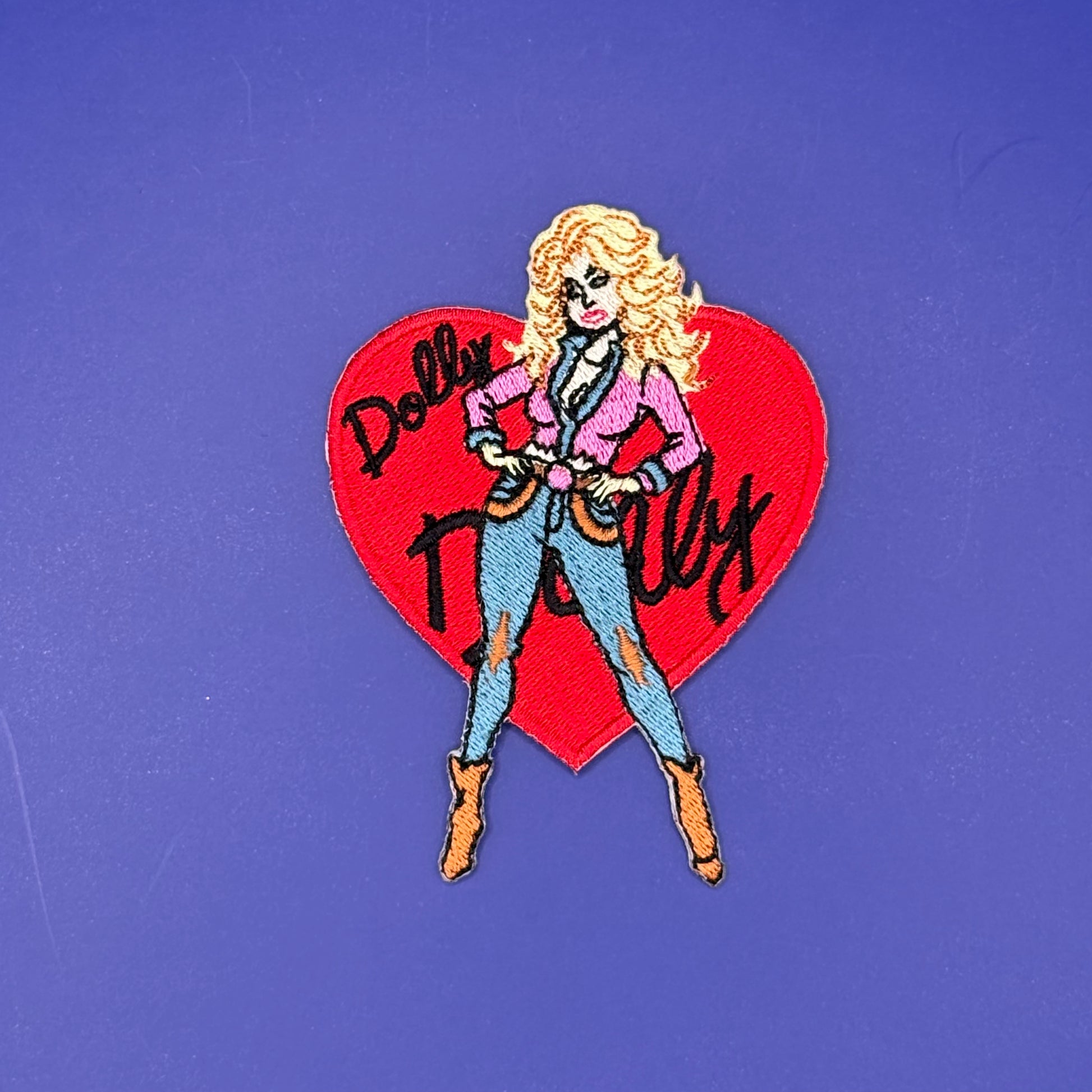 Dolly Parton heart iron-on patch with pink jacket and cowboy boots over a red heart