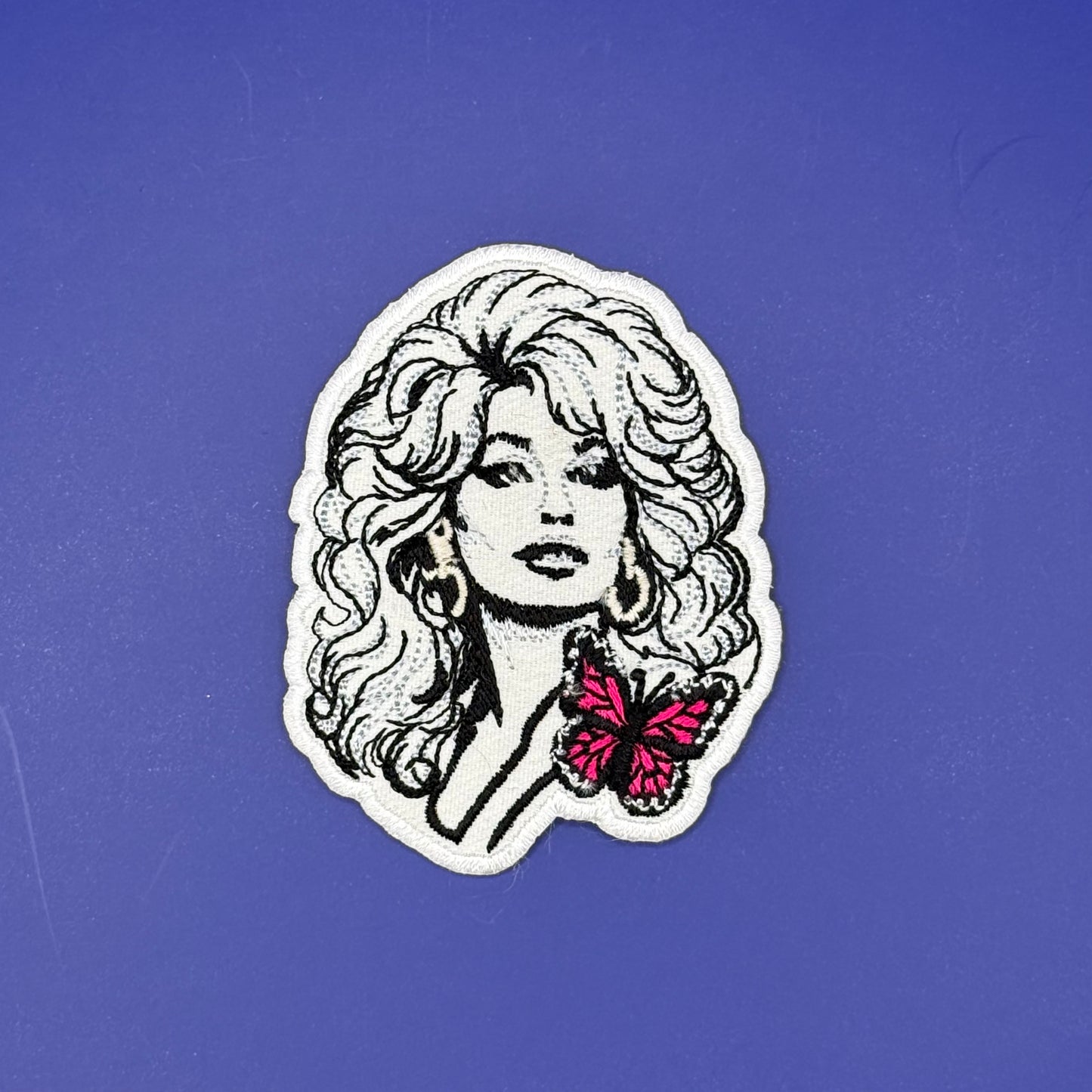 Dolly Parton black-and-white portrait iron-on patch with pink butterfly