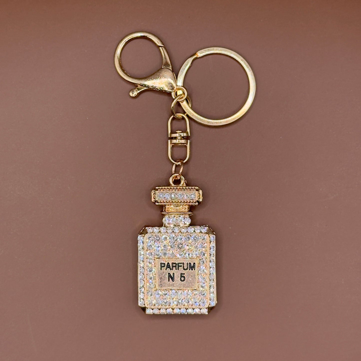 Rhinestone perfume bottle keychain in white