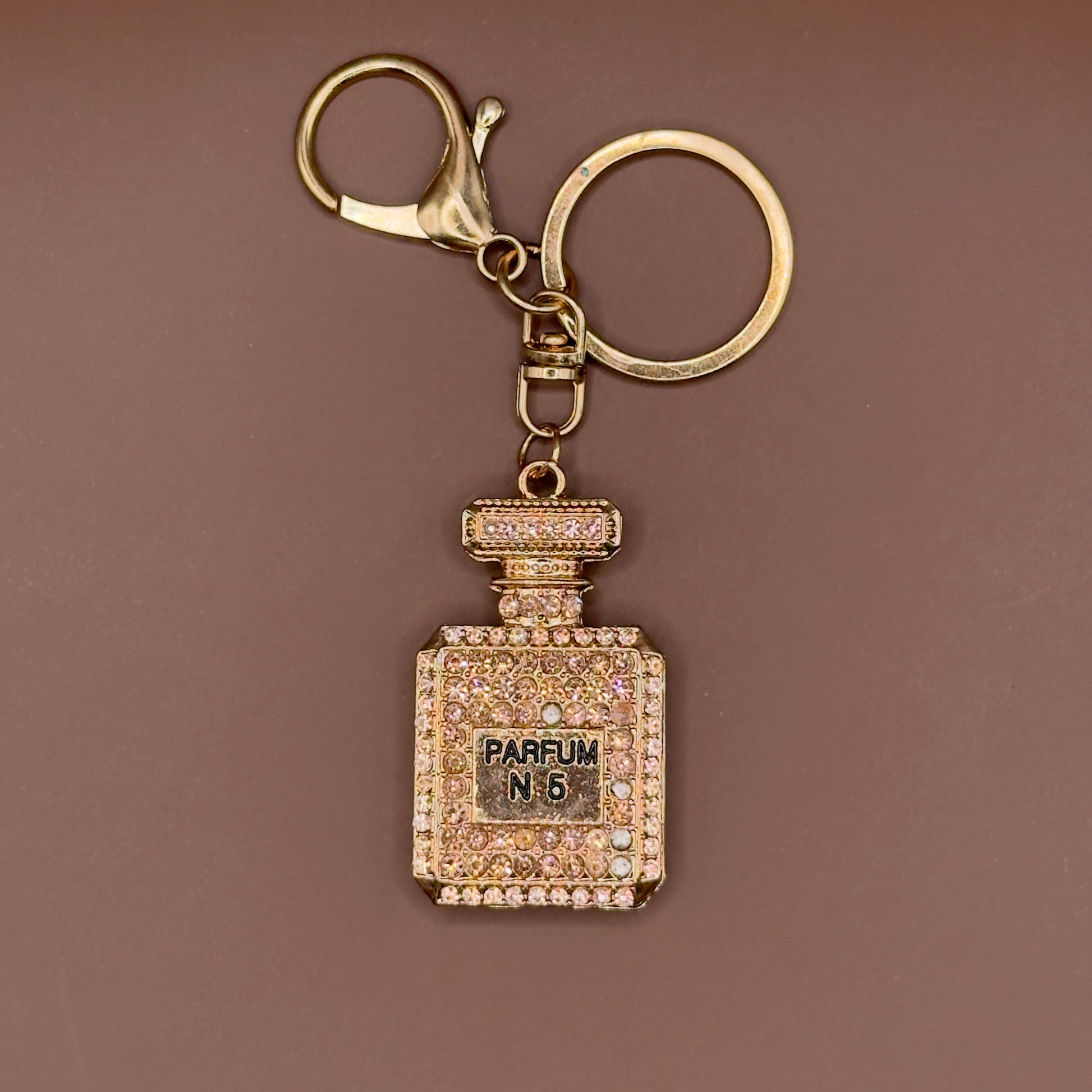 Rhinestone perfume bottle keychain in gold
