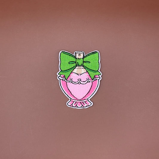 Glamorous pink perfume bottle embroidered patch with green bow