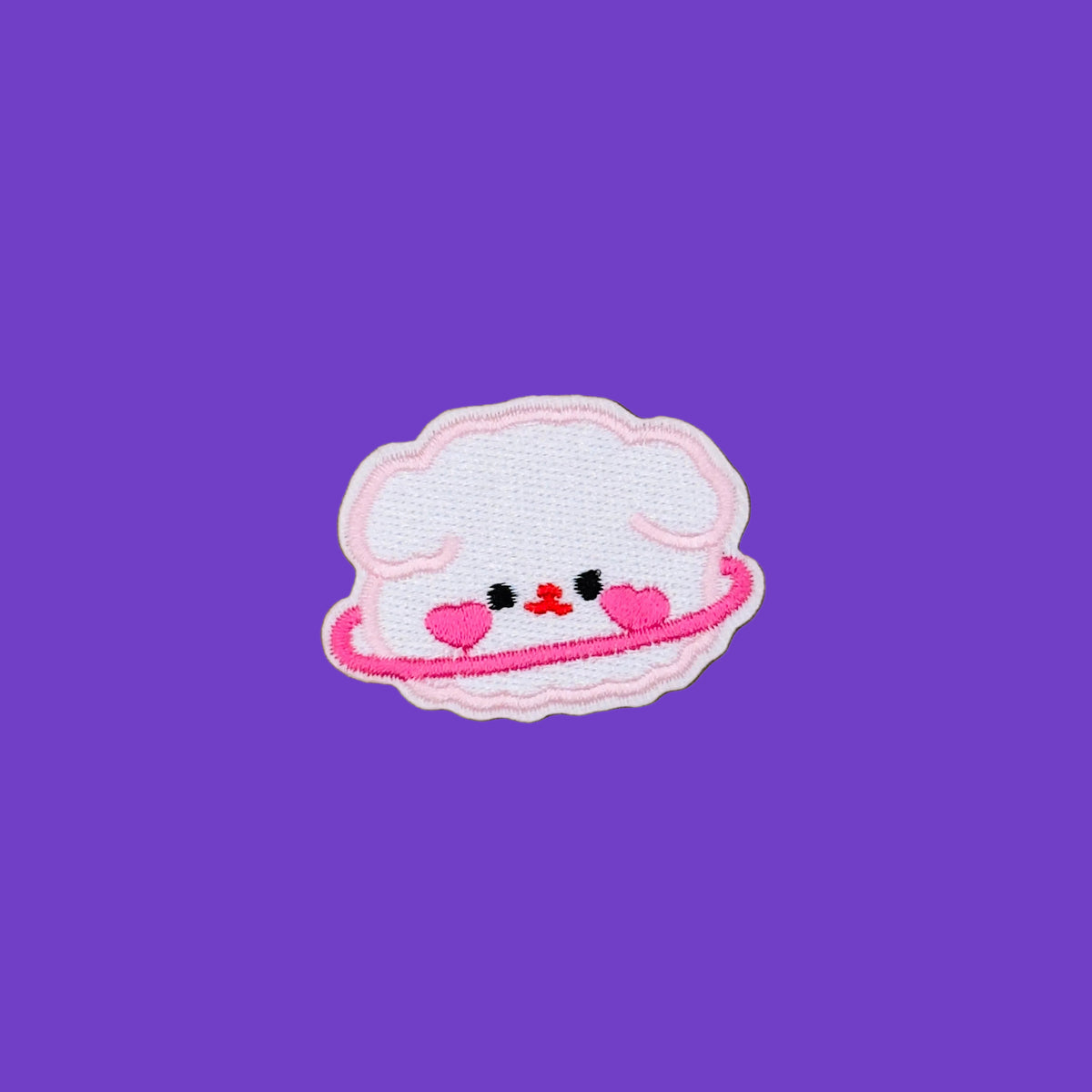 A cute embroidered patch shaped like a smiling white cloud with a pink border, pink heart-shaped cheeks, and a small red smiley face. 