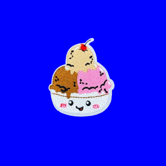 Iron-on patch of three smiling ice cream scoops in a bowl with a cherry on top