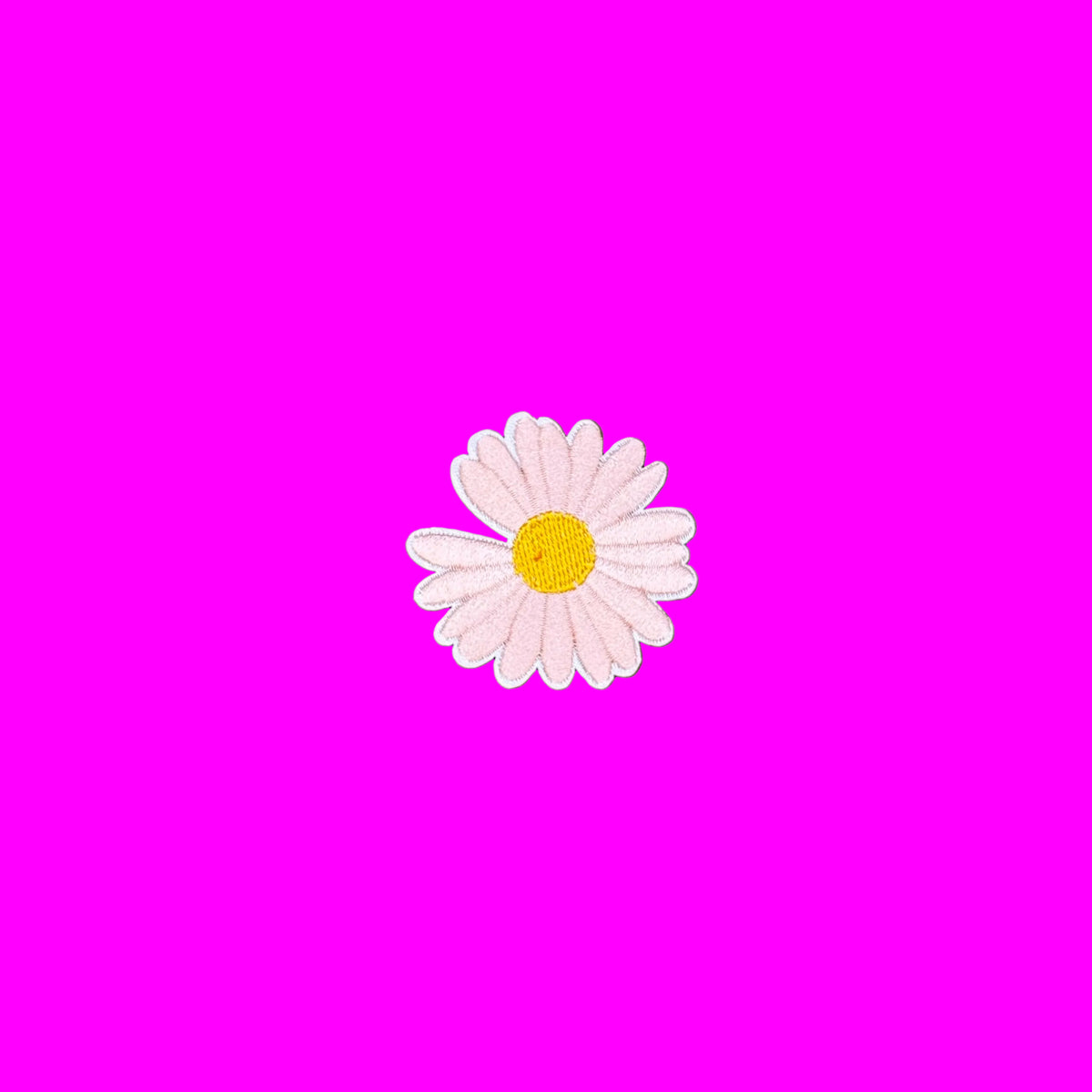 Blush pink daisy embroidered iron-on patch with a golden center
