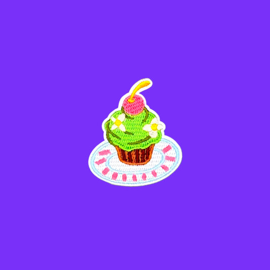 Matcha cupcake with cherry on a plate iron-on patch