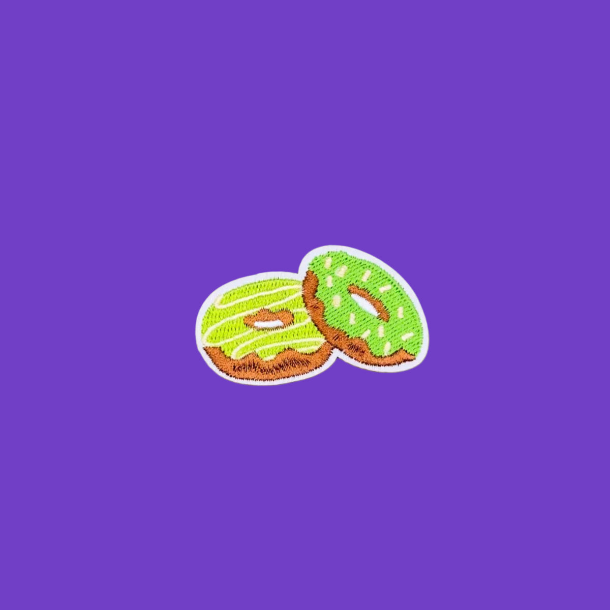 A pair of green frosted matcha donuts embroidered iron-on patch.