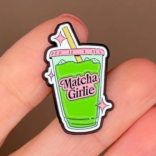 Matcha Girlie enamel pin — green iced matcha cup with pink sparkles, close-up