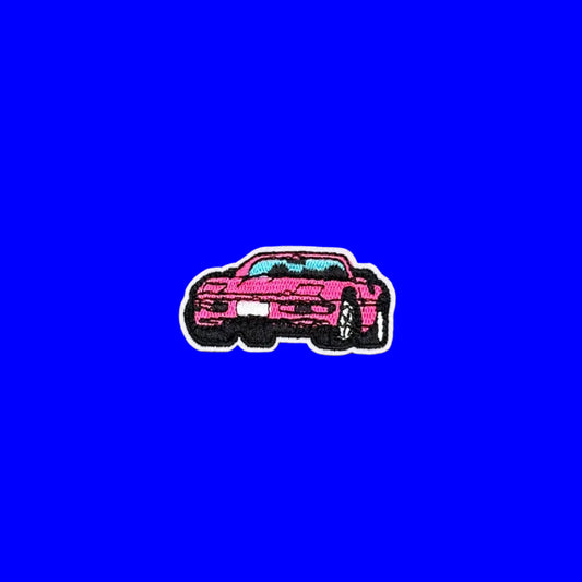 Hot pink sports car iron-on patch in profile with a turquoise windshield