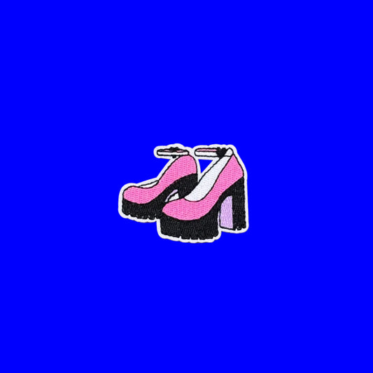 Iron-on patch of pink ankle-strap heels on chunky black platforms