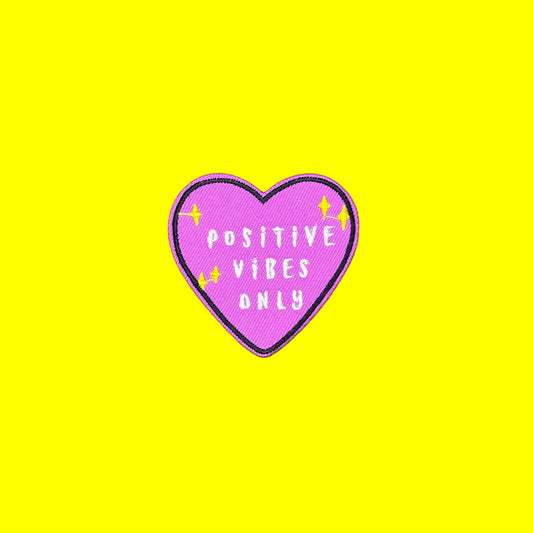 Purple heart iron-on patch with white Positive Vibes Only lettering and yellow sparkles