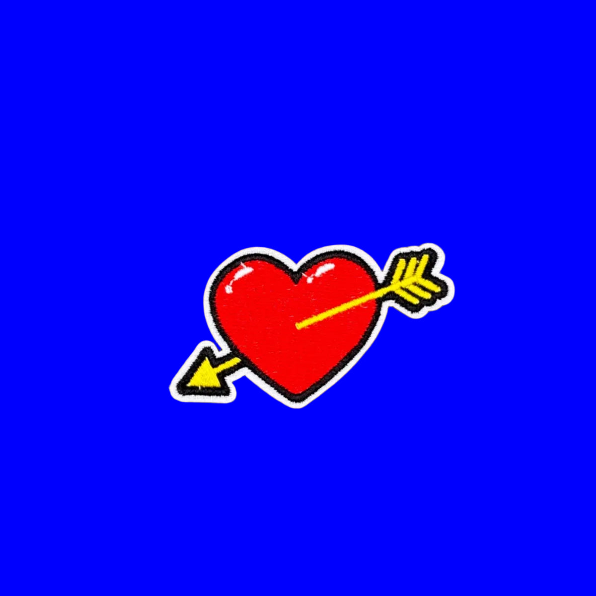 Red heart with yellow cupid's arrow embroidered iron-on patch.