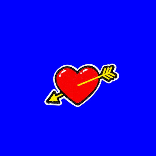 Red heart with yellow cupid's arrow embroidered iron-on patch.