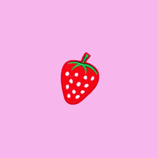 Classic red strawberry iron-on patch with white seeds and a green leafy top